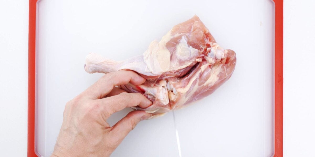 Cut through joint in chicken leg.