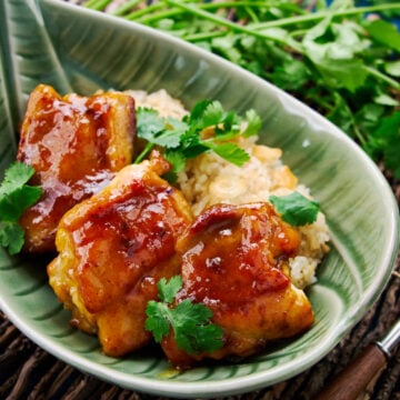 Spicy savory curry chicken glazed in a sticky mango chutney glaze served with a side of a garlic rice.