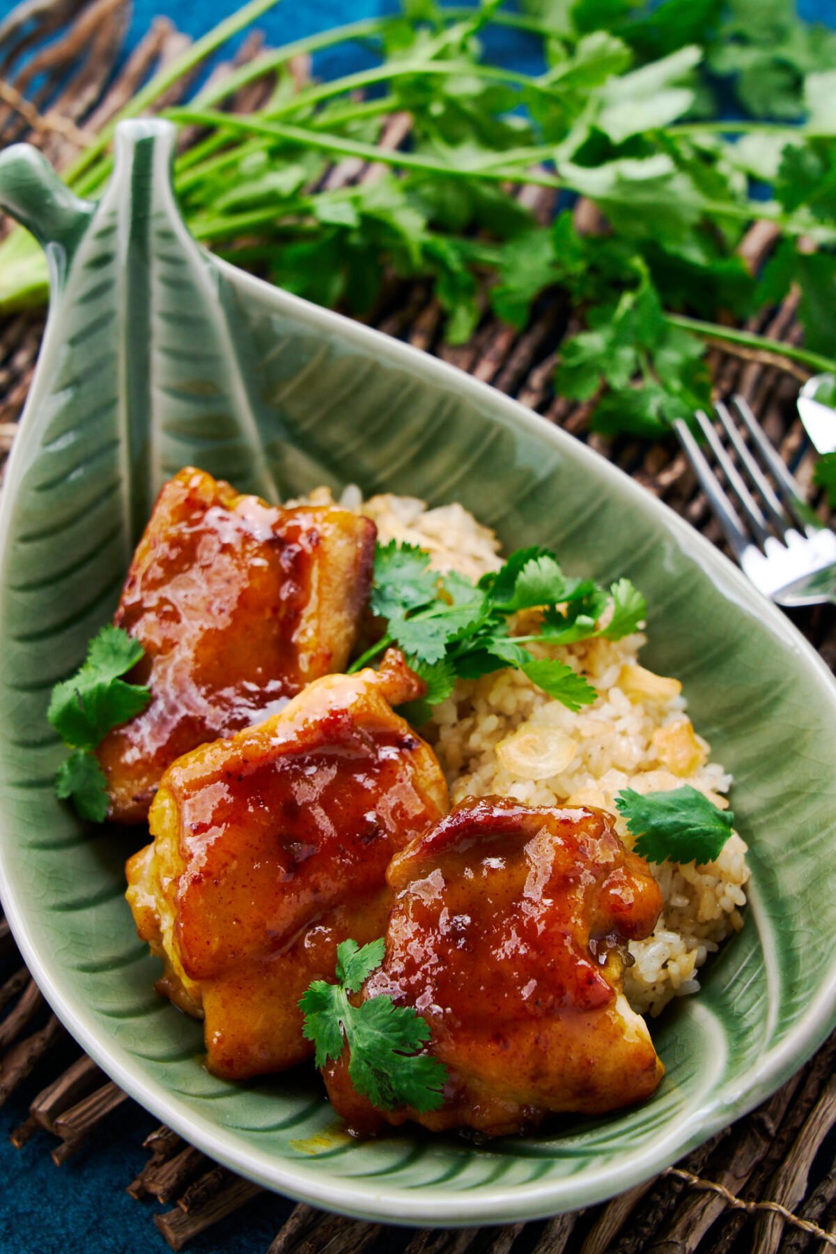 This easy weeknight curry chicken is glazed in a sweet and sticky mango chutney glaze. It comes together in minutes and goes great with a side of garlic rice.