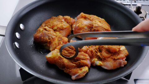 Pan-frying chicken on the skin-side.