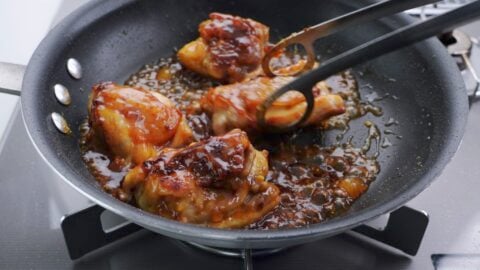 Glazing chicken with mango chutney.