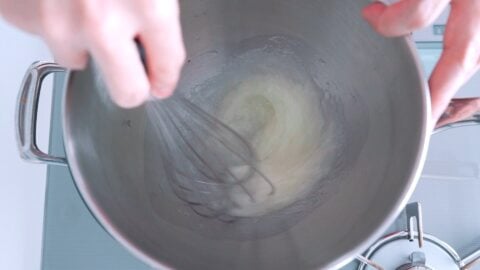 Heating egg whites and sugar for meringue.