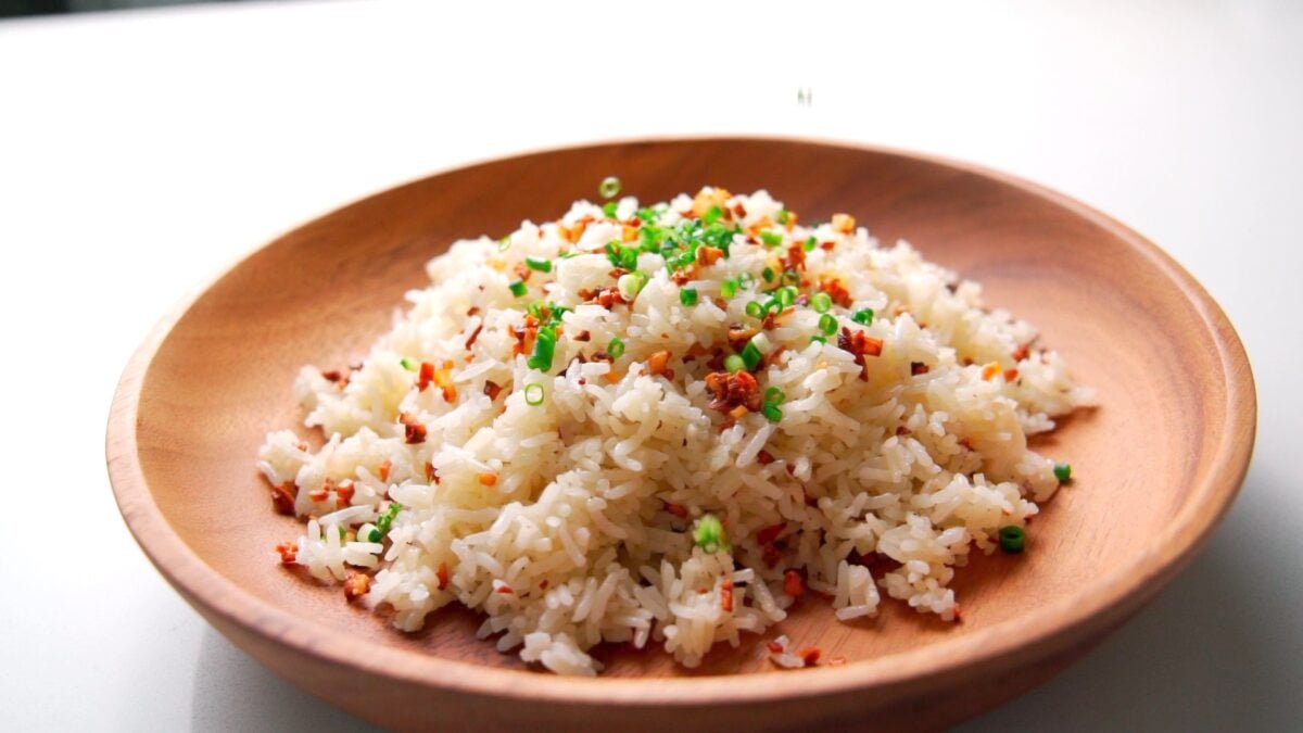 Sinangag or Filipino Garlic Fried Rice served in a wooden plate.