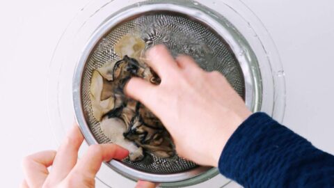 Rinsing oysters in water.