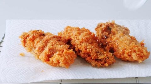 Crispy deep fried oysters draining on paper towels.