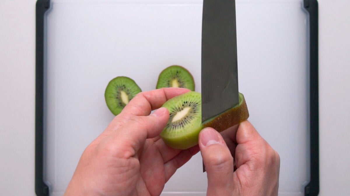 Peeling kiwifruit for fruit sandwiches.