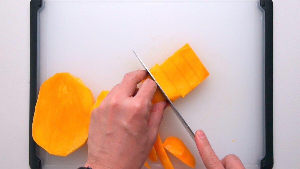 Slicing mango into batons for fruit sandwiches.