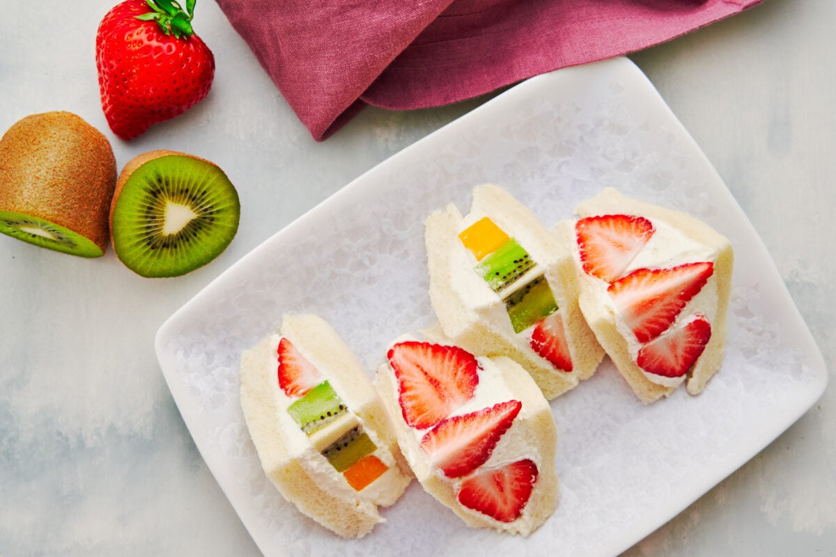 Japanese-style fruit sandwiches loaded with fresh fruit and whipped cream.