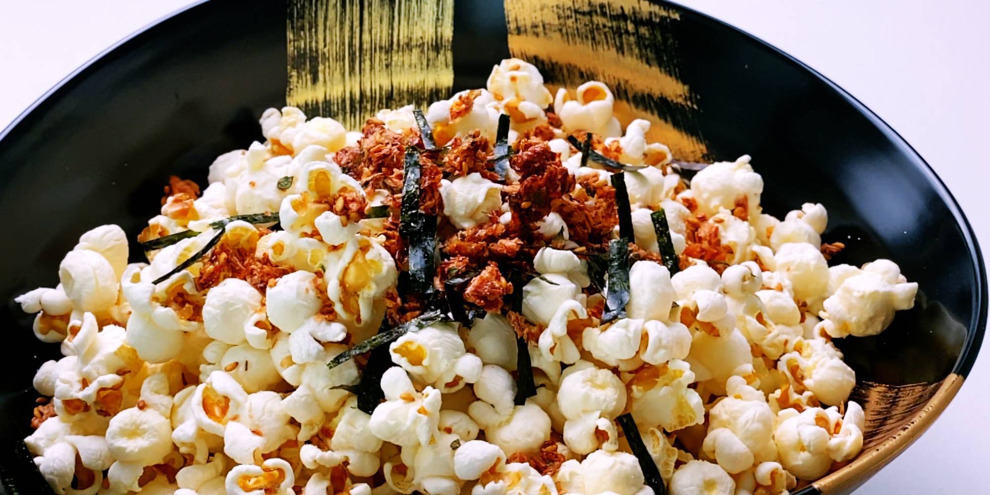 A bowl of popcorn sprinkled with Furikake seasoning.