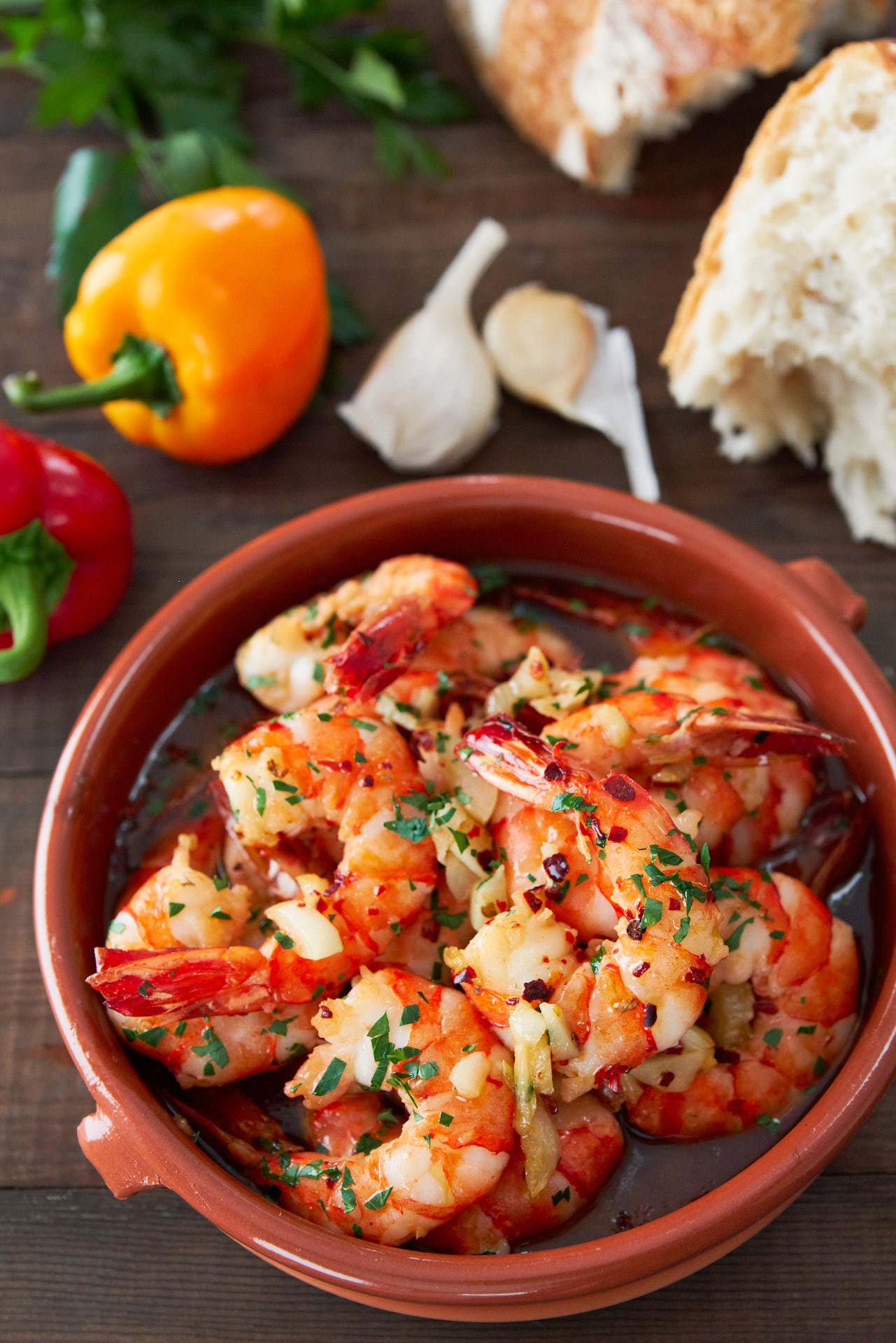 With plump juicy shrimp cooked with loads of garlic browned in olive oil, Gambas al Ajillo (garlic shrimp) is an easy Spanish tapa that comes together in about five minute. Be sure to have some bread handy to sop up the delicious briny oil.