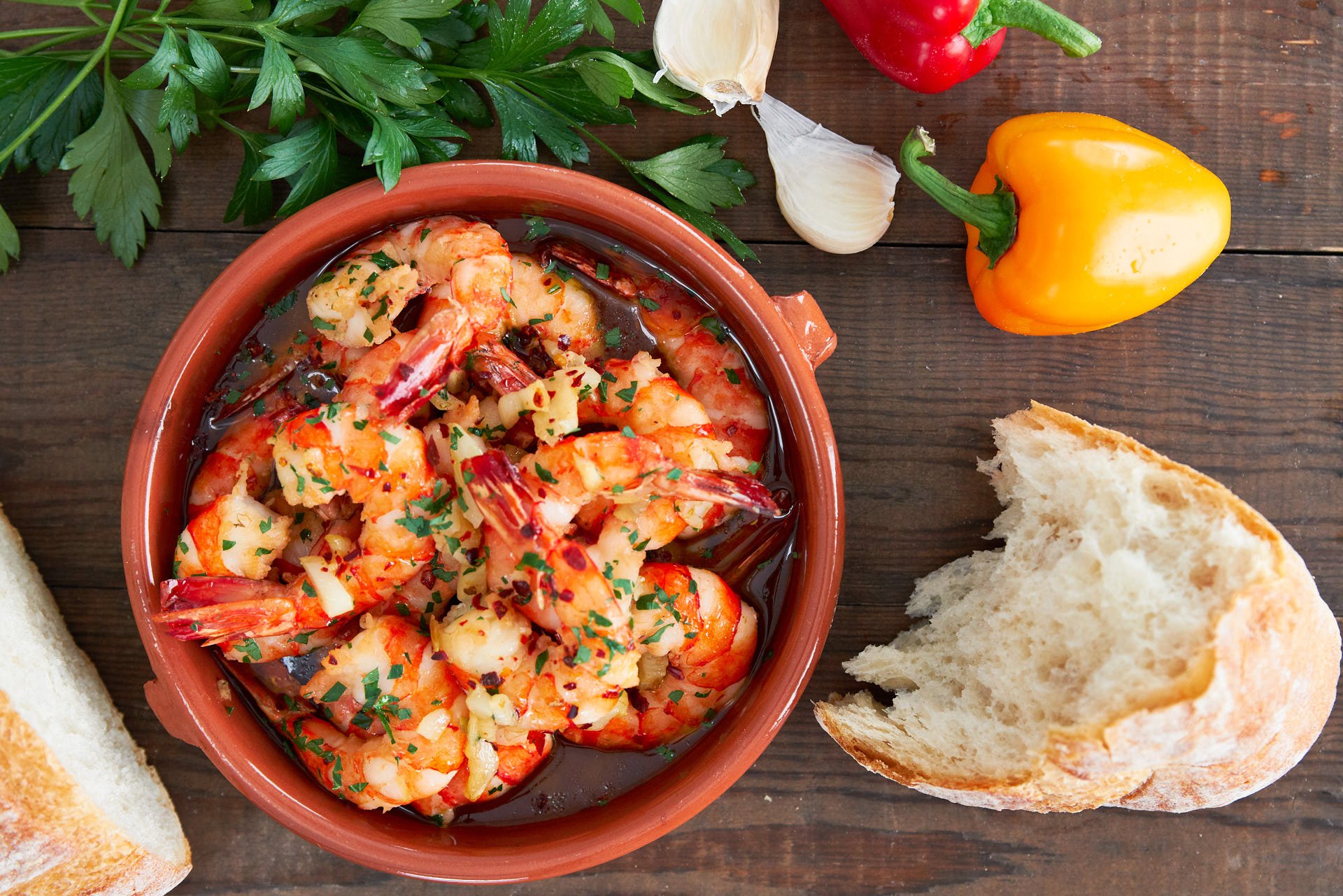 Gambas al Ajillo, or garlic shrimp in a Cazuela de Barro is an easy and delicious Spanish Tapa that comes together in minutes from a handful of ingredients.