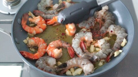 Making the best Gambas al Ajillo with shrimp, olive oil and garlic.