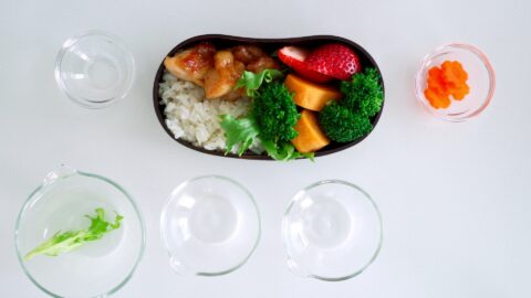 A strawberry is added to the Ginger Chicken Bento.