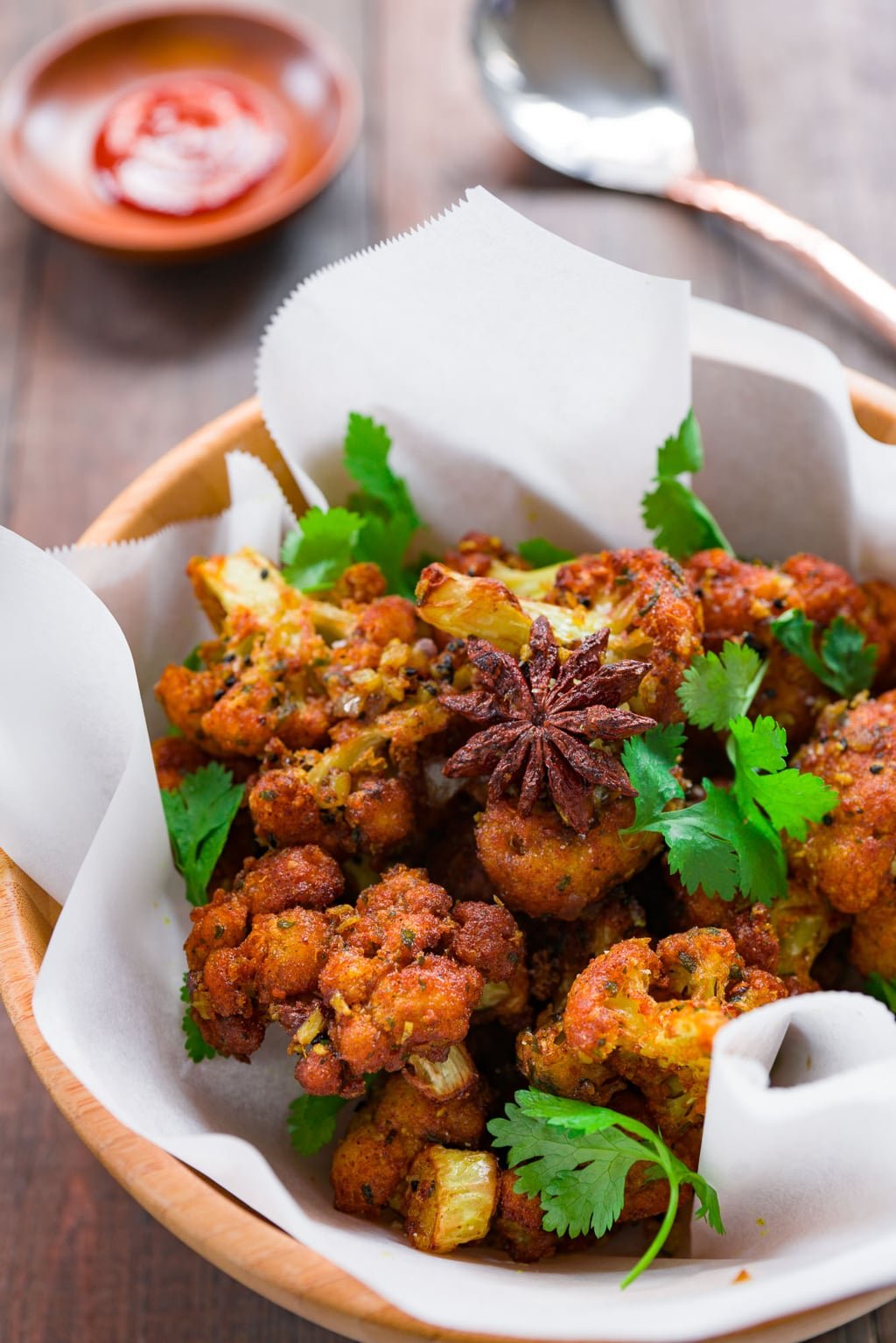 Gobi 65 (Cauliflower 65) is the consummate bar-snack of Chennai with crisp florets of cauliflower tossed with tempered spices and aromatics.