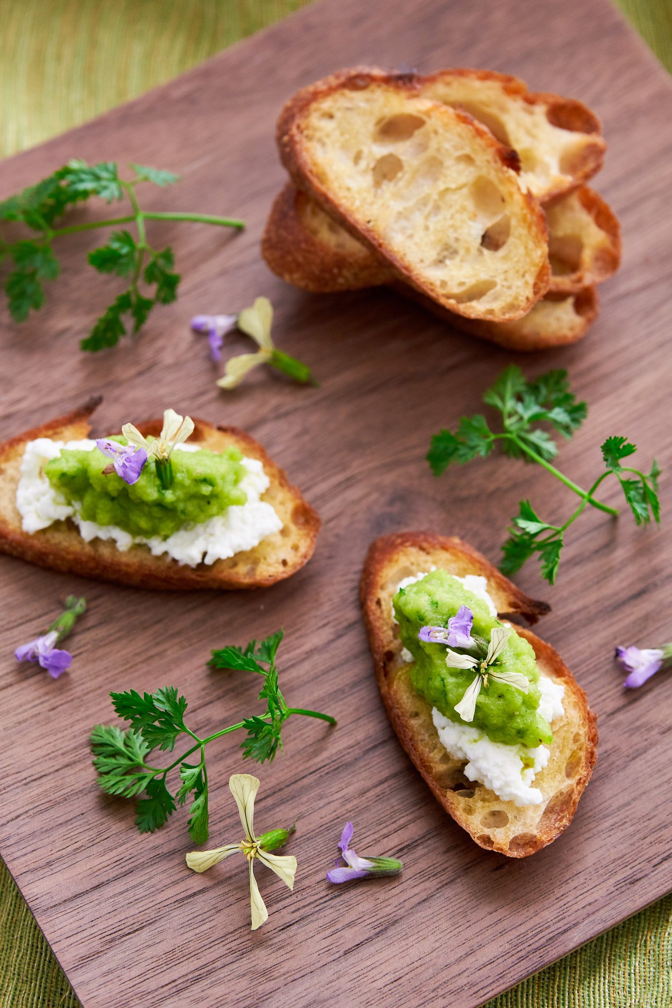 Delicious 5 ingredient Green Pea Pesto Recipe is the perfect spring canape on crostini, spread in sandwiches, or tossed with pasta.