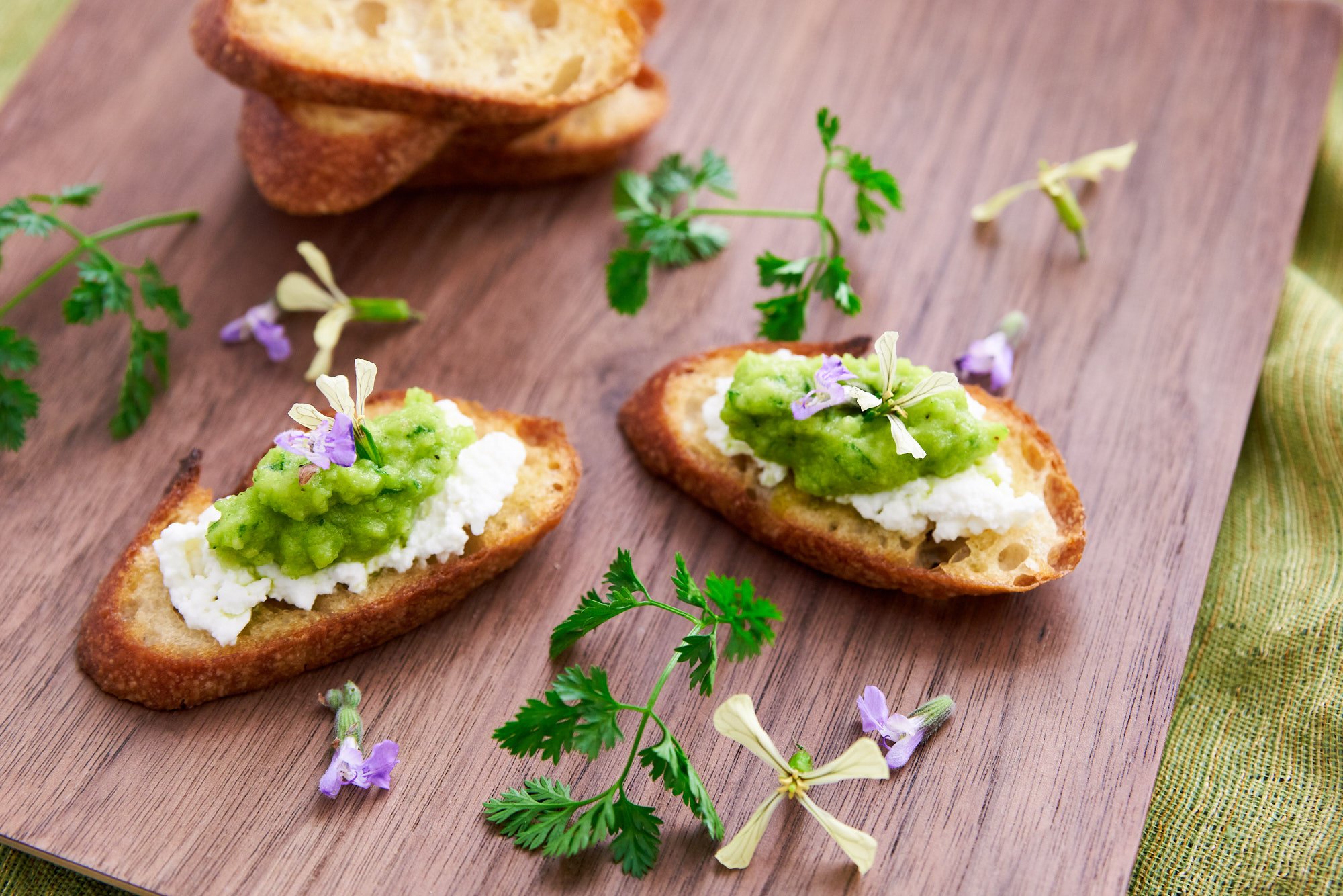 Perfect spring green pea pesto with ricotta spread on crostini.