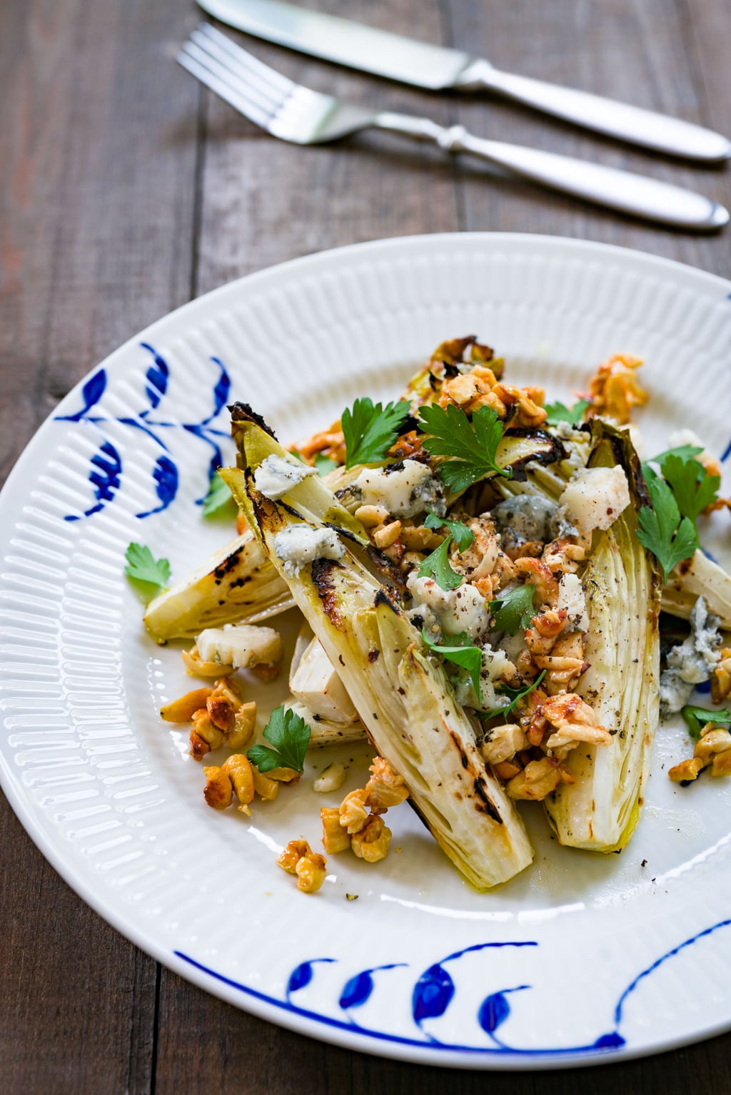 A delicious grilled endive salad with marinated char-grilled endives, honey roasted cashew nuts and gorgonzola cheese.