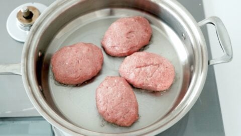 Frying Japanese-style Hamburg Steak (Hambagu) in a pan.