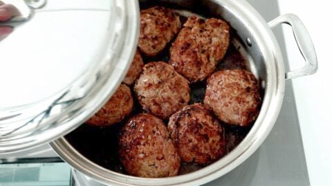 Steaming Hambagu in a pan with red wine.