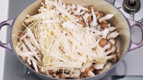 Crimini, shimeji, and enoki mushrooms in pot.