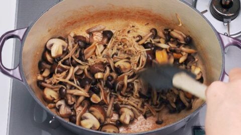 Sauteing mushrooms until browned.