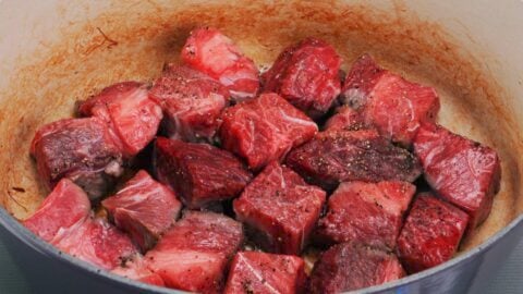 Large pieces of stew meat in pot.