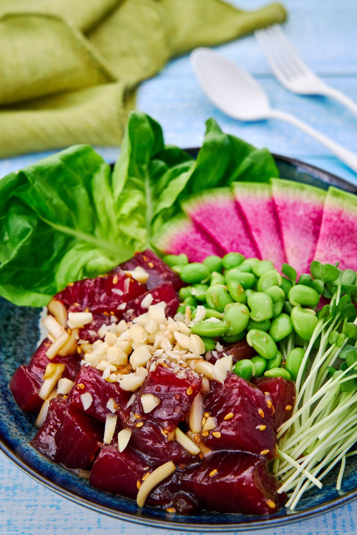 Ten minutes is all you need to make this delicious Ahi Tuna Poke Bowl at home. With velvety cubes of marinated tuna and a rainbow of veggies, it's an easy nutritious meal that's sure to please.