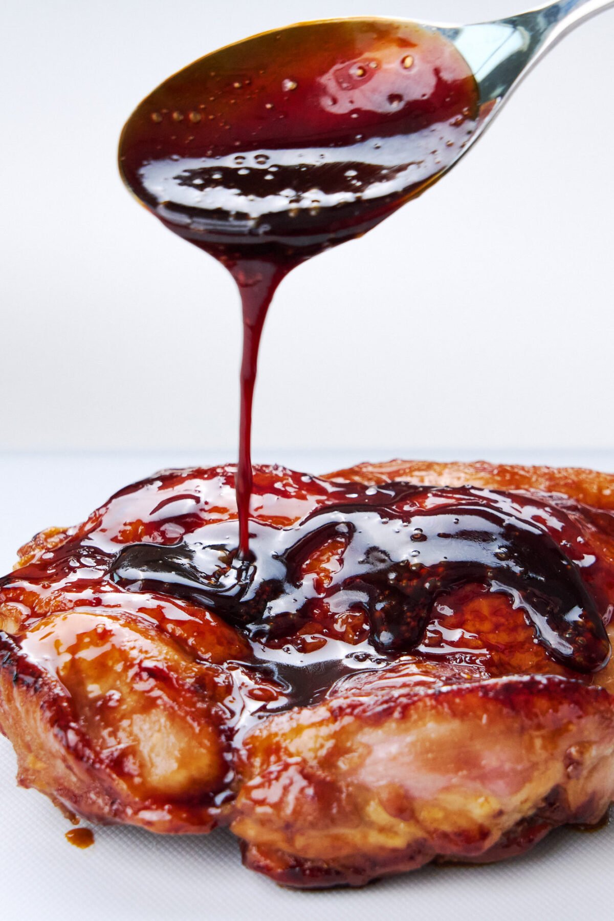 Drizzling authentic Japanese teriyaki sauce over chicken.