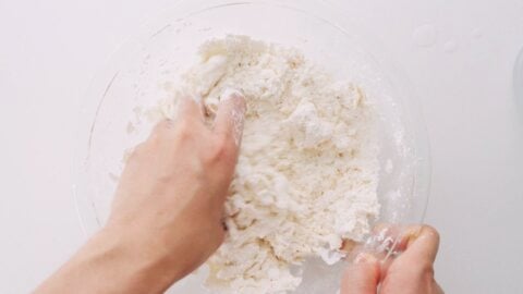 Mixing brine with flour to make udon dough.