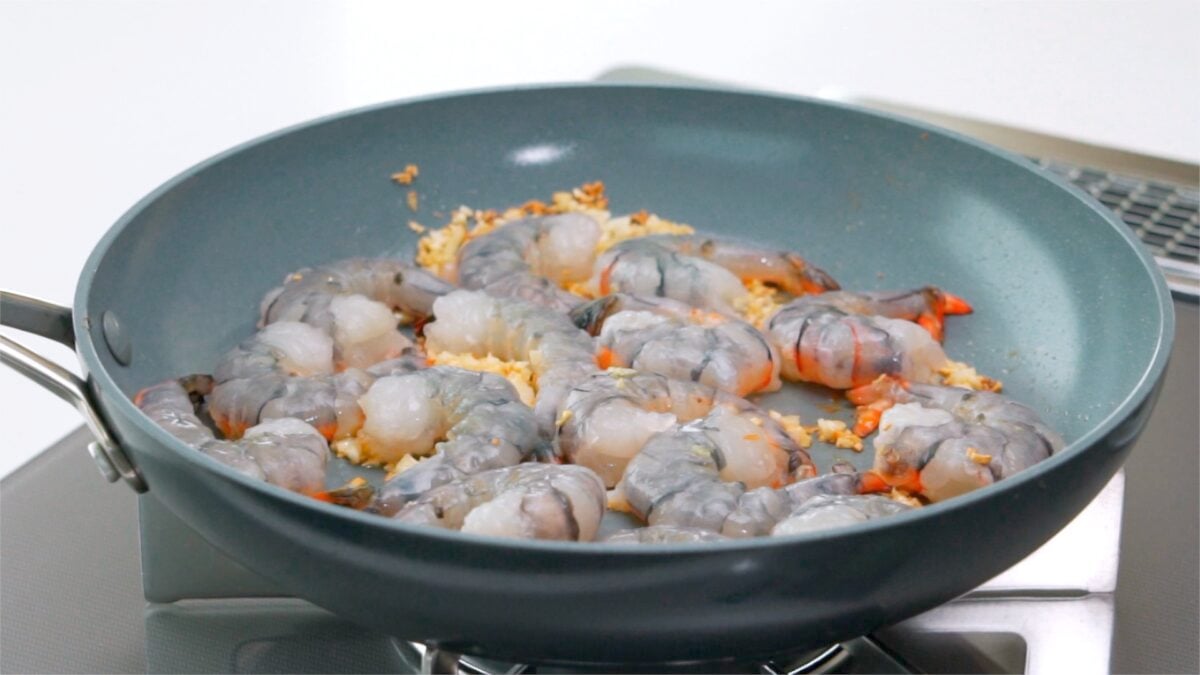 Shrimp and garlic frying in a pan.