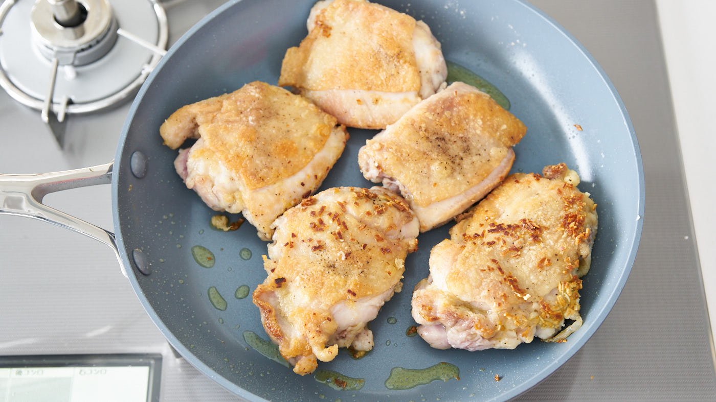 Browned chicken and garlic for making the best honey lemon chicken.