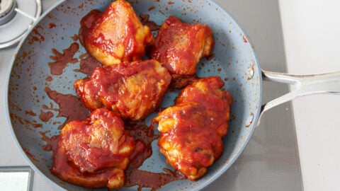 Chicken thigh pieces covered in honey lemon and tomato sauce.