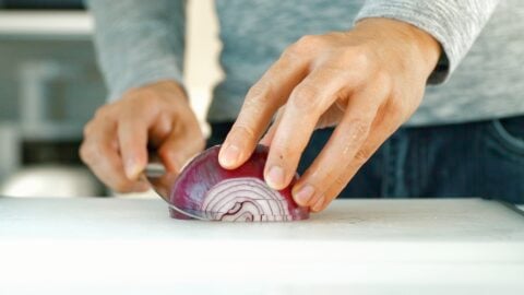 Cutting slits in the side of the onion makes it easier to chop.