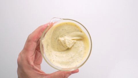 Yuzu mayonnaise in a glass bowl.