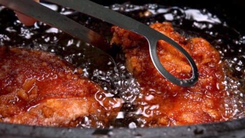 Golden brown Chicken Karaage (Japanese fried chicken) being removed from oil.