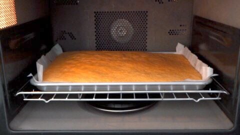 Baking the cake in the oven.