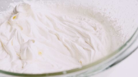 Whipped cream in glass bowl.