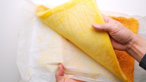 Removing parchment paper for sponge cake.