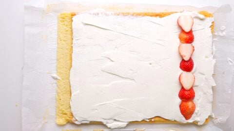 Lining up strawberries for Christmas Cake roll.