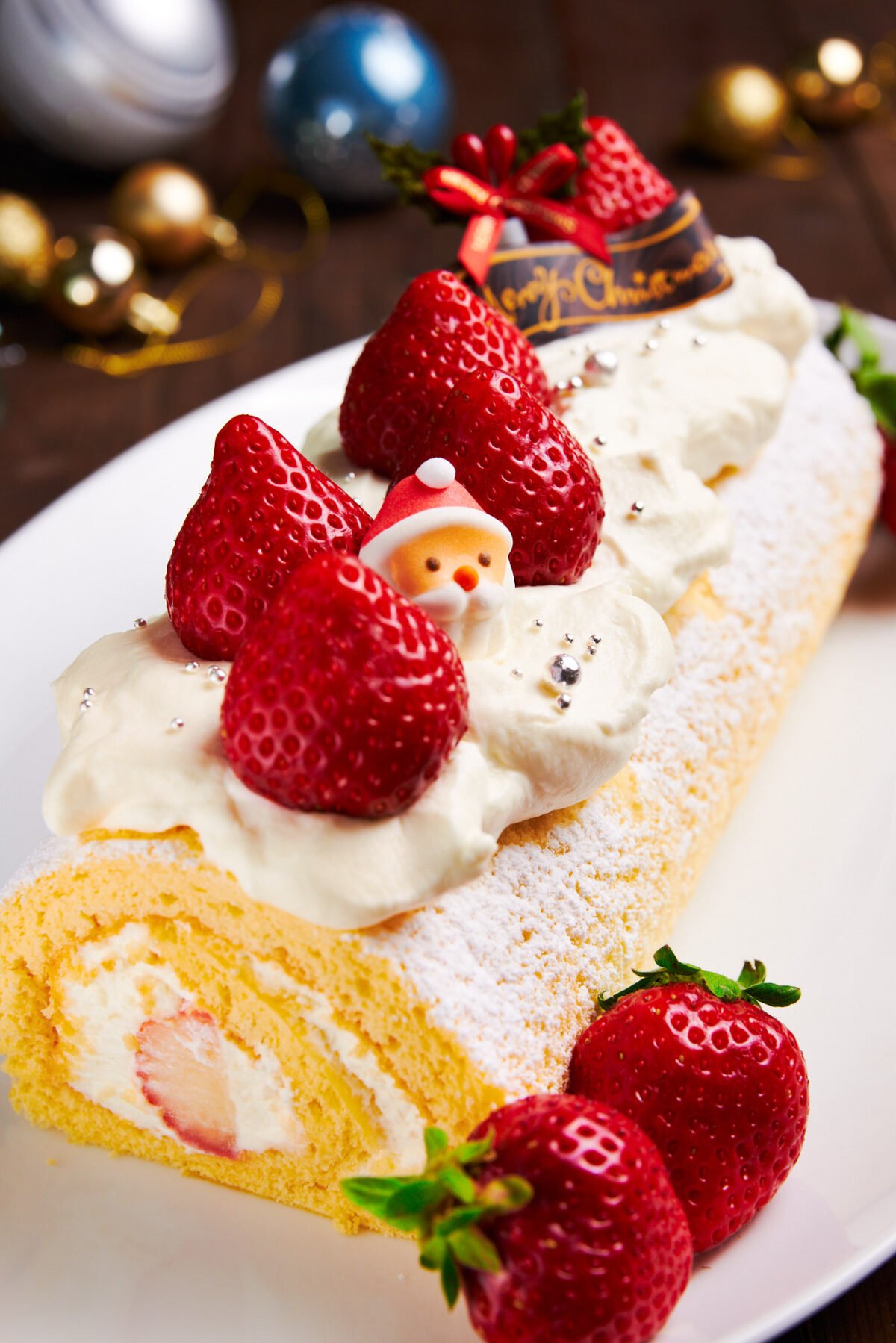 This mouthwatering Japanese Christmas cake is made with a tender spongecake rolled with stawberries and cream.