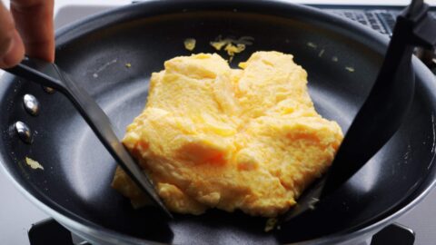 Shaping dashimaki tamago in a round pan.