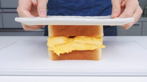 Pressing Tamagoyaki Sandwich with a plate.