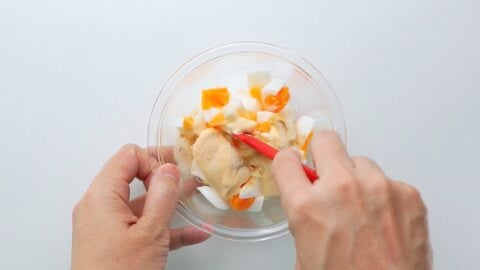 Mixing chopped boiled eggs along with Japanese mayonnaise and seasonings to make an egg salad.