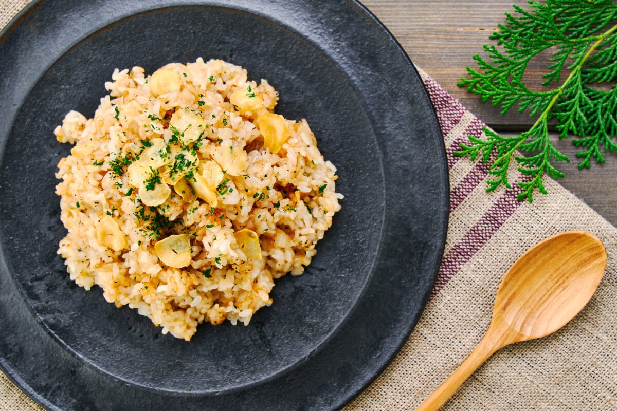 A plate of Japanese garlic rice topped with crispy garlic chips.