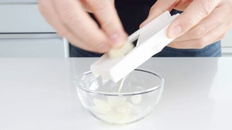 Slicing garlic chips using mandoline.