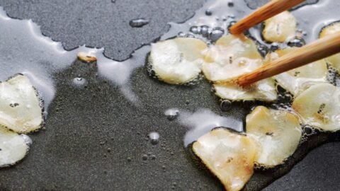 Crispy browned garlic chips in oil.