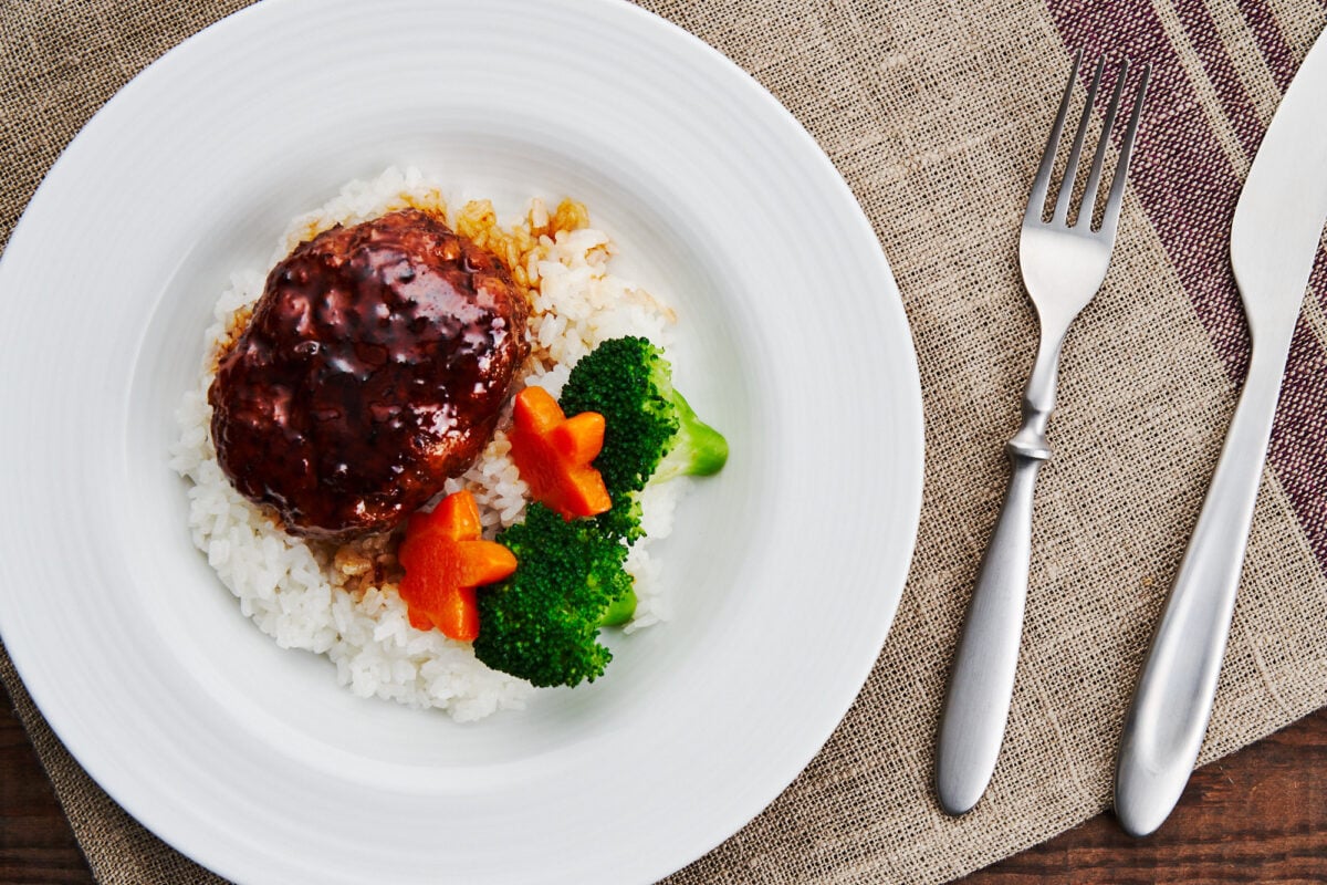 Japanese Hamburger Steak and teriyaki sauce over rice with steamed broccoli and carrots.