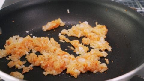 Sautéing ginger, garlic, onions, and miso for Mapo Tofu.