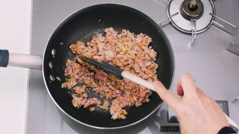 Stir-frying ground pork an aromatics for making Japanese-style Mapo Tofu.