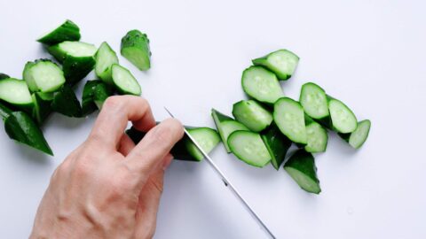 Slicing Japanese cucumbers into an oblique cut.